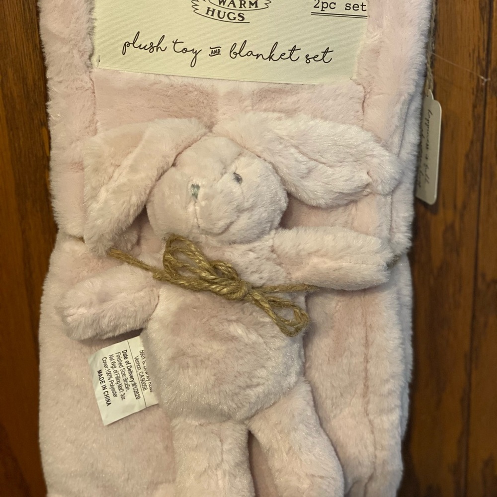 Plush pink blanket with plush toy